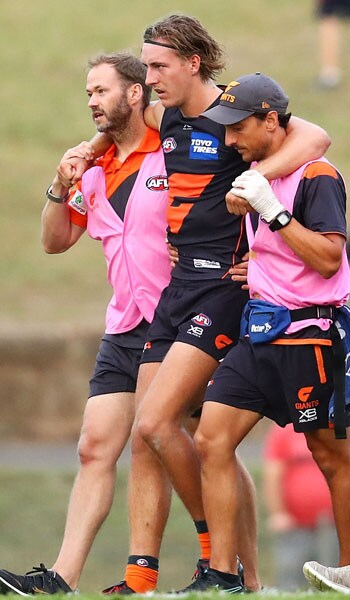 SETTERFIELD-KNEE-SLIDER.jpg Will Setterfield is helped from the ground after injuring his knee against the Swans. - GWS Giants,Isabel Huntington,Will Setterfield,AFL